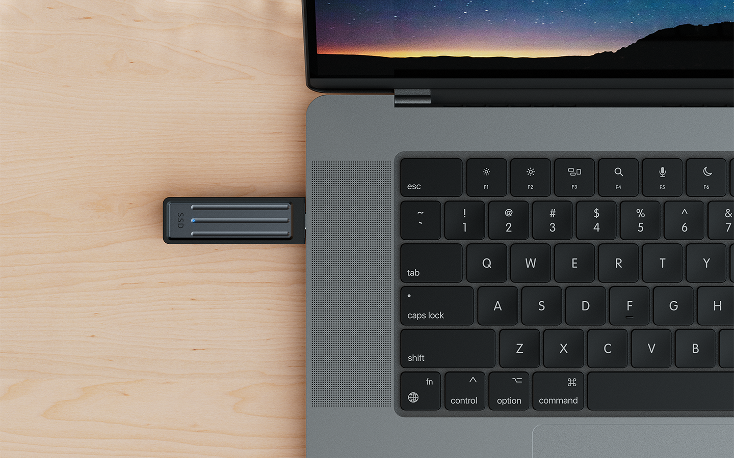 Seagate Ultra Compact external SSD is plugged into a MacBook Pro via USB-C, highlighting its portable, on-the-go design.