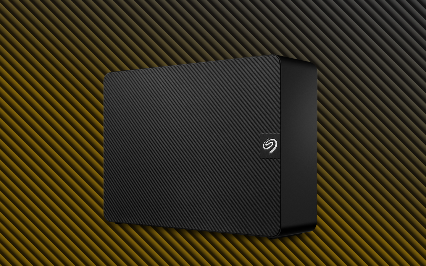 Seagate Expansion external desktop drive stands angled to the left.