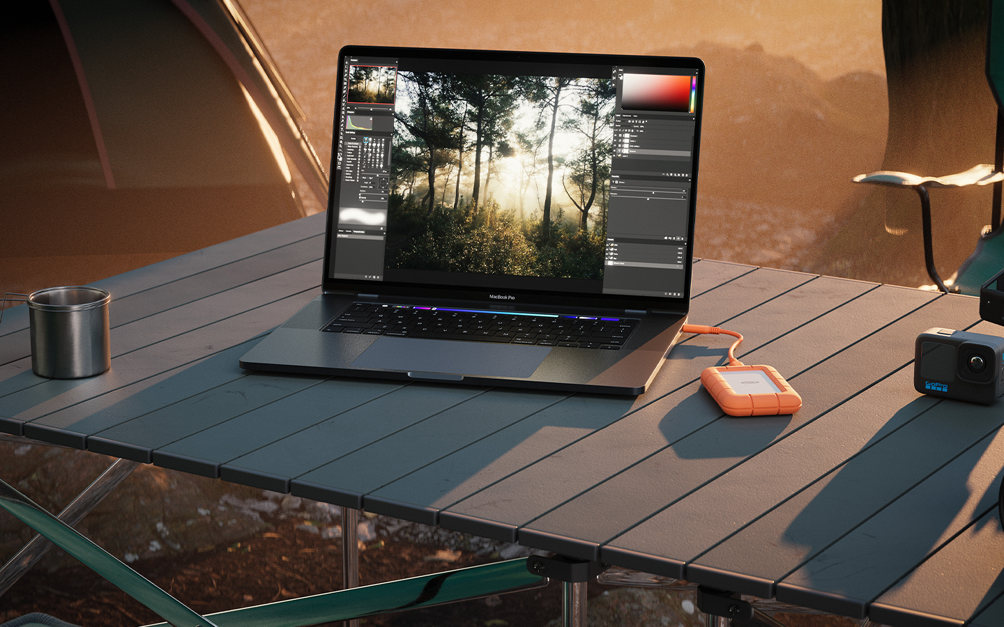 Laptop on an outside table is connected to a LaCie Rugged Mini SSD, showing its durability.