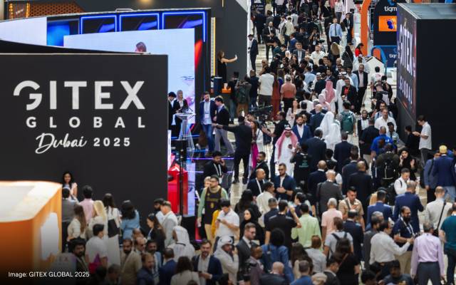 Overhead view shows a large crowd of attendees at GITEX Global 2025 in Dubai moving through exhibition halls showcasing the latest advancements in technology.