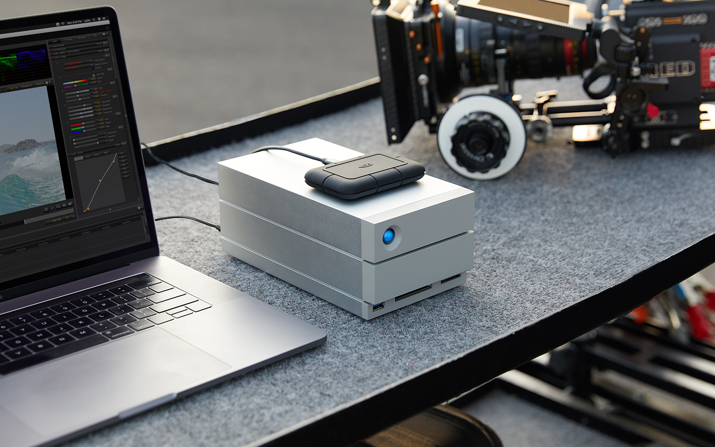 Up-close view of a LaCie Rugged SSD Pro5—connected to a laptop—sits atop a LaCie 2big Dock.