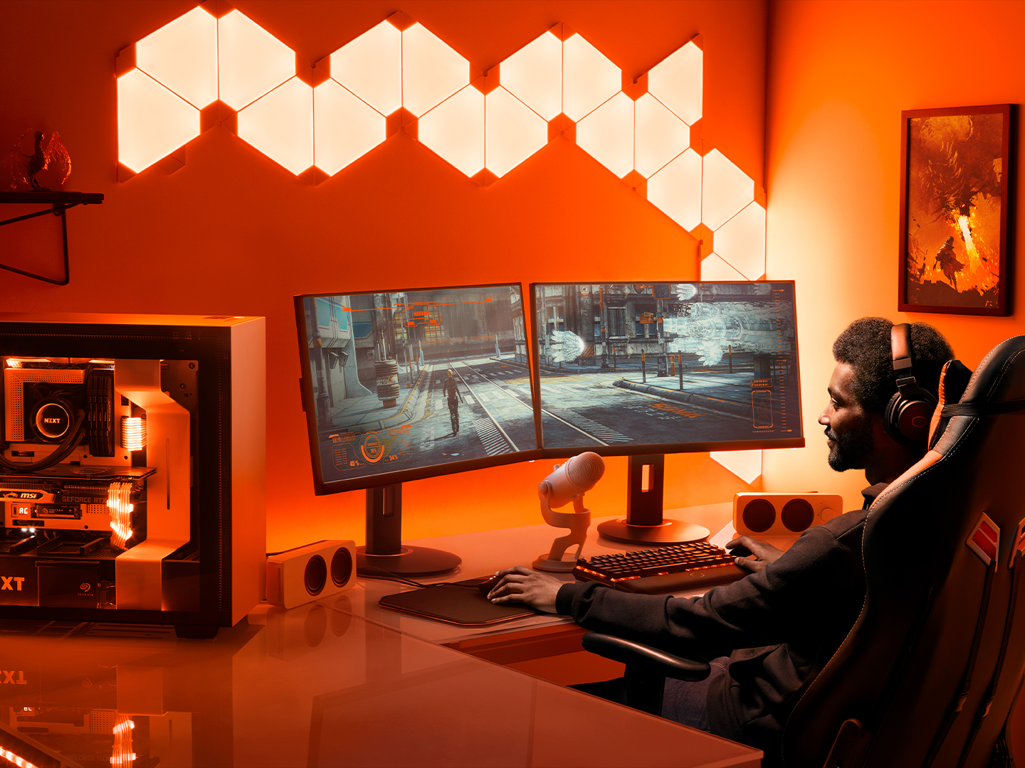 Wearing headphones, a person sits in a gaming chair playing on dual screens with a see-through hard drive to the left.