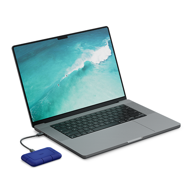 A LaCie Rugged Pro5 drive is shown plugged into a laptop.