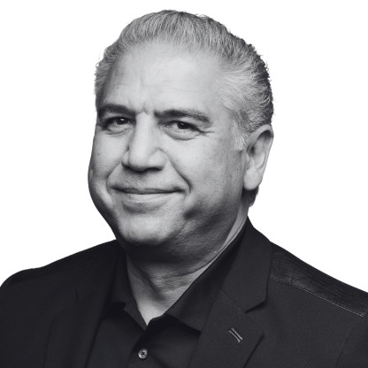 Black-and-white professional headshot of Mohamad El-Batal, Technologist, wearing a suit jacket is shown.