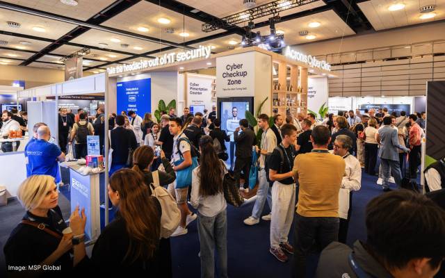 Crowd of attendees networking and exploring booths at MSP Global 2025 conference, which is focused on IT security and cyber solutions.